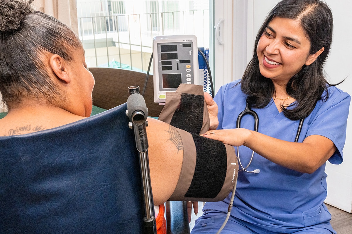 A nurse assisting a woman at Medical Hill