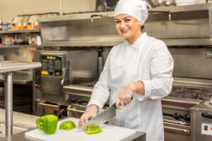 A chef cutting peppers at medical hill