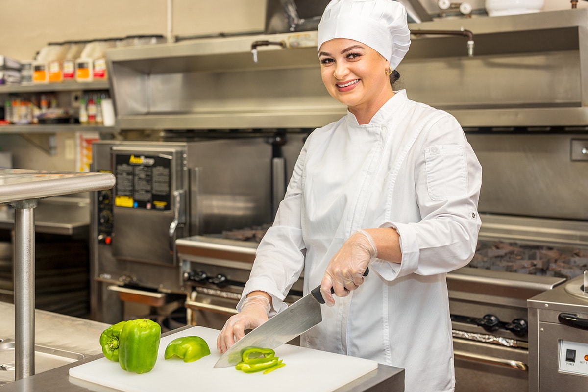 A chef cutting peppers at medical hill